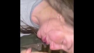 Mature woman, homeless, finds solace with discovered bottle.